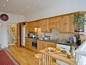 a kitchen with wooden cabinets and a counter top at Upper Knutsford in Exmouth