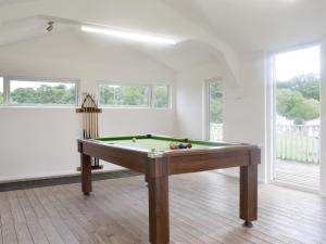 a living room with a pool table in it at Sunset in Cheriton Bishop
