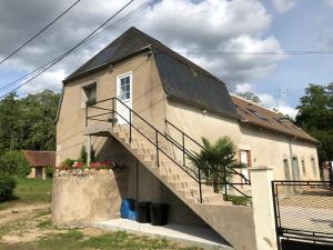 a house with a staircase on the side of it at Le champ des granges in Briare