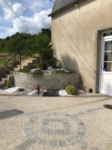 a house with a door and a stone driveway at Le champ des granges in Briare