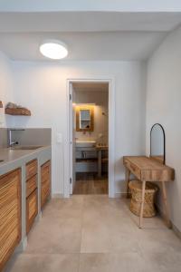 uma cozinha com um lavatório e uma mesa em Drios Luxury Studios em Drios