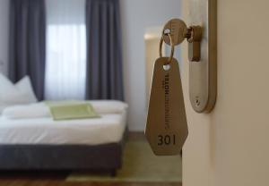 Postel nebo postele na pokoji v ubytování Gartenstadt Hotel