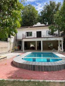 a house with a swimming pool in front of it at Casa Capistrano in Iguala de la Independencia
