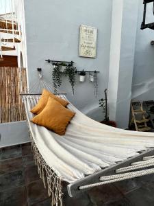 a hammock bed in a room with plants on the wall at Sunshine loft in Gran Alacant