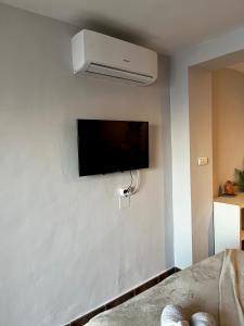 Habitación con TV de pantalla plana en la pared en Sunshine loft, en Gran Alacant