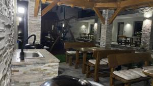 a kitchen with a sink and a table and chairs at Eugen Apartmán in Veľký Meder +23 photos