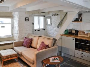 a living room with a couch in a kitchen at Haven Cottage - 28269 in Port Isaac