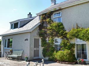 a house with a bench in front of it at Didfa - 27912 in Llangoed