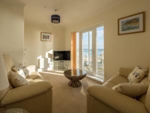 a living room with two couches and a large window at Culver View in Shanklin