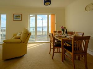 a dining room with a table and a chair at Culver View in Shanklin