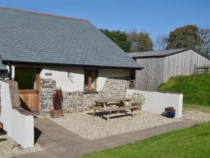 a picnic table in front of a building at Bramble in Hartland