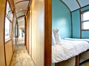 a room with two bunk beds in a bus at Brunel Boutique Railway Carriage 5 in Dawlish Warren