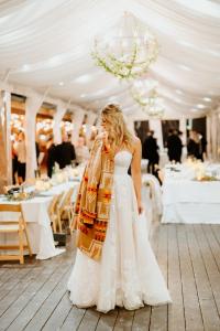 a bride in a white dress standing in front of a marquee at Rainbow Ranch Lodge in Big Sky Canyon Village