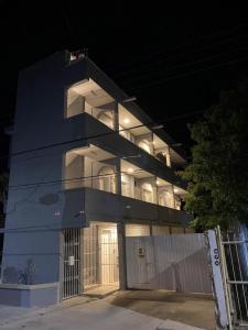 a blue building with a balcony at night at 8th Street Suites in Cozumel