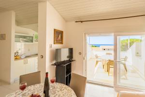 a kitchen with a table and a view of the ocean at Erica perfect central location near beach in Novalja