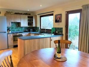 a kitchen with a table with a bottle of wine on it at Rosmuire in Rhu