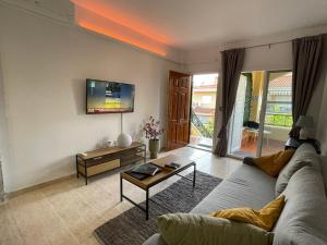 a living room with a couch and a table at Modern Apartman - Novamar 1 in Gran Alacant