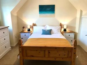 a bedroom with a bed with two night stands at 10 Berisay Place in Stornoway