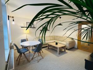 a living room with a couch and a table at Apartments Dombergblick - Suhl, Stadtmitte in Suhl