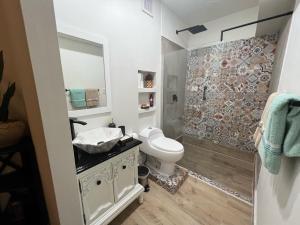 a bathroom with a toilet and a sink and a shower at 310Guest-House La Vida in San Juan +171 photos