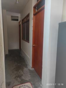 an empty hallway with a door and a room at La casa de Joan in Máncora
