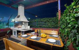 a outdoor table with a grill and bananas on a patio at Villa Fay Split in Split
