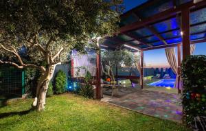 an outdoor patio with a tree and a pool at Villa Fay Split in Split