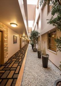 a hallway with potted plants in a building at Prime Hotel in Fort McMurray