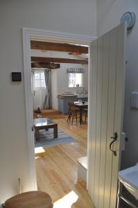 an open door to a living room with a kitchen at The Hay Loft Southlands Farm in Gunnerton
