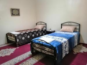 a bedroom with two beds and a rug at Takad Dream Rural in Takate +25 photos
