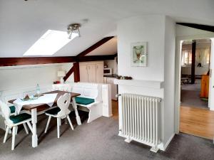a kitchen and dining room with a table and chairs at Landhaus Bellecôte in Reit im Winkl