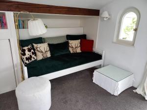 a couch in a small room with a window at Landhaus Bellecôte in Reit im Winkl