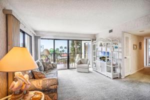 a living room with a couch and a table with a lamp at Land's End 1-307 Gulf View in St. Pete Beach