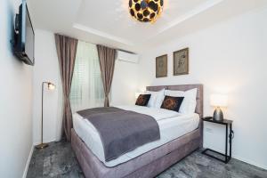 1 dormitorio con 1 cama grande y TV en Apartment Misto, en Split