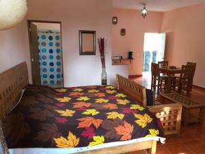 um quarto com uma cama com um cobertor colorido em Hotel Villas Monteli Suites Cuernavaca em Cuernavaca