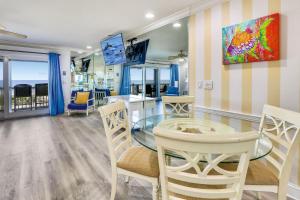 a dining room with a glass table and chairs at Sunset Villas 1 in Clearwater Beach