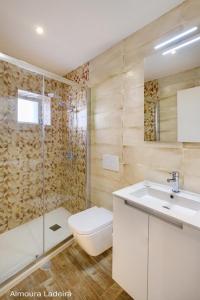 a bathroom with a sink and a toilet and a shower at Almoura Ladeira in Évora