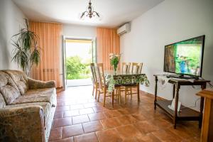 a living room with a table and a couch at Apartment Nina in Rovinj
