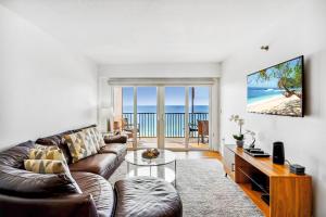 a living room with a couch and a view of the ocean at Villa Madeira 505 - Premier in St. Pete Beach