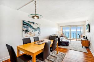 a dining room and living room with a table and chairs at Villa Madeira 505 - Premier in St. Pete Beach