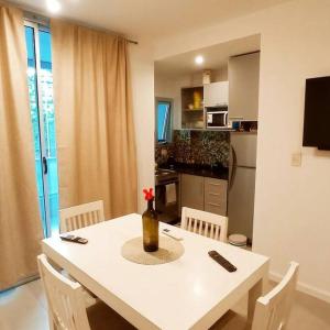 a kitchen with a table with a vase with a flower on it at Nb1 apartment free parking con cochera privada in Buenos Aires