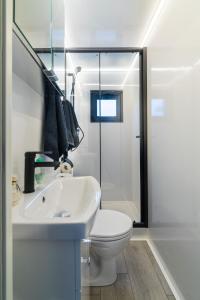 a white bathroom with a toilet and a sink at TRAUMZEITBOOT auf dem Scharmützelsee Bad Saarow in Bad Saarow