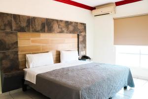 Postel nebo postele na pokoji v ubytování Hotel Gina