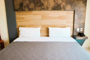 Postel nebo postele na pokoji v ubytování Hotel Gina
