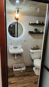 a bathroom with a toilet and a sink and a mirror at depa #5 recién remodelado en planta alta in Zacatecas +6 photos