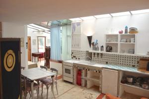 a kitchen with a table and a table and chairs at Le Quinquerlet in Apt