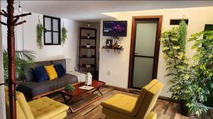 a living room with a couch and chairs and a tv at depa #5 recién remodelado en planta alta in Zacatecas