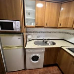 a small kitchen with a sink and a microwave at Apartamentos Turísticos La Posada in Oropesa