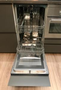 an open dishwasher with its door open in a kitchen at Central penthouse with spectacular sea and city views in Genova