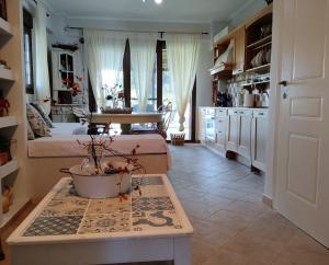 a kitchen and a living room with a table with a potted plant at High aesthetics maisonette in the wood by the sea in Metamorfosi